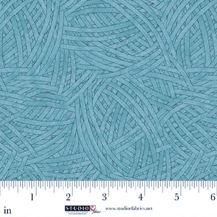 Teal fabric with a textured pattern and a ruler for scale at the bottom.
