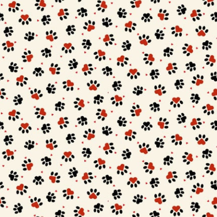 Pattern of black paw prints and red hearts on a beige quilting cotton fabric