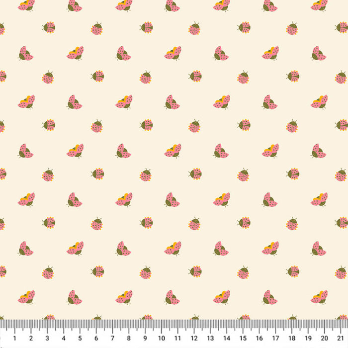 Ladybirds printed on a cream cotton quilting fabric with a cm ruler