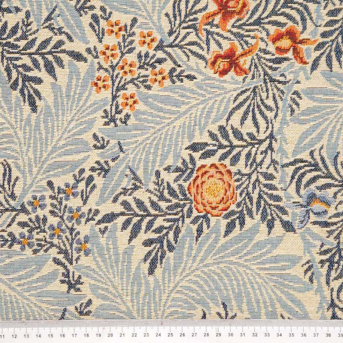 Floral and leaf pattern fabric with orange flowers on a blue background