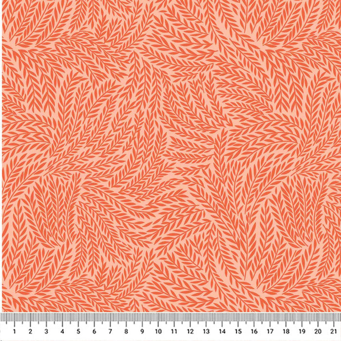 A textured leaf design on orange quilting fabric with a cm ruler
