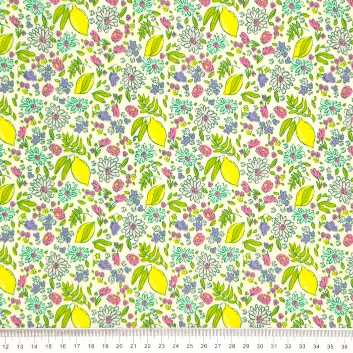 Lemons and ditsy flowers printed on a white polycotton fabric with a cm ruler