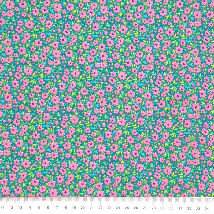Ditsy flowers and lime green vines on a dark green polycotton fabric with a cm ruler