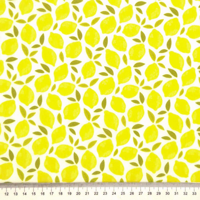 Lemons printed on a white polycotton fabric with a cm ruler