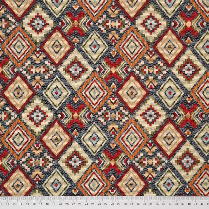 An aztec print on an upholstery tapestry fabric with a cm ruler