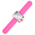 Pink slap bracelet with a silver clasp and colourful pins on a white background