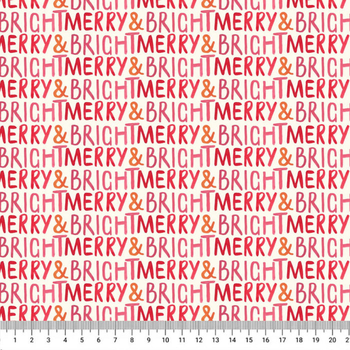 A repeating pattern of 'BRIGHT MERRY & BRIGHT MERRY' text in coral pink and orange on a white cotton quilting fabric, with a ruler along the bottom edge showing scale.