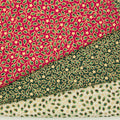 Mini holly and stars in a gold lacquer are printed on red, green and ivory 100% cotton christmas fabric