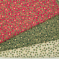 Mini holly and stars in a gold lacquer are printed on red, green and ivory 100% cotton christmas fabric