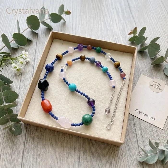 Multi-gemstone crystal choker necklace on wrist, showing 8 healing stones in rainbow colors, Crystalvana