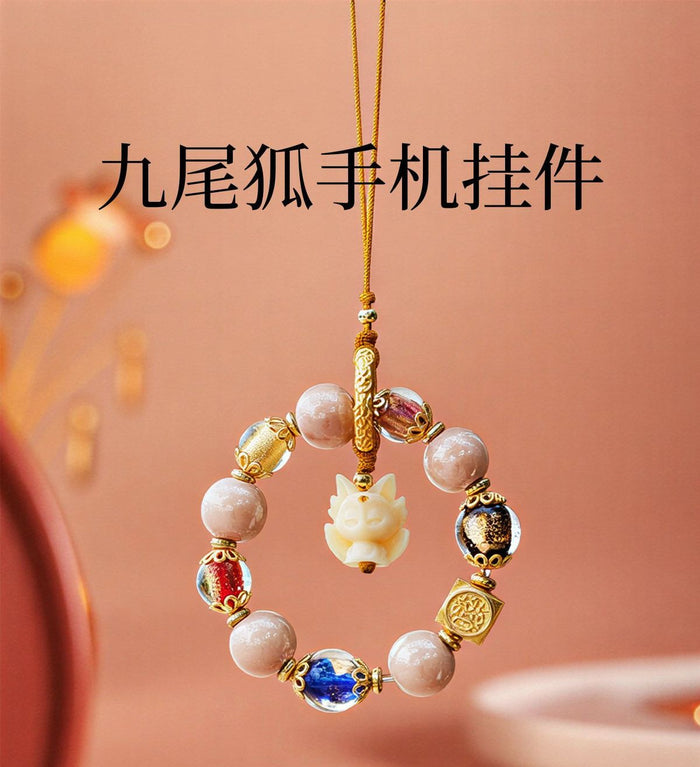 Nine-Tailed Fox crystal pendant flat lay - handcrafted phone charm for prosperity