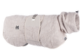 Stock image of the Drying Robe, in the sand colour, on a transparent background. Features hexagon lines, with Non-stop branding.