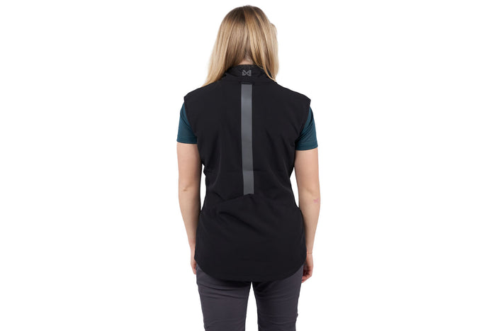 A woman wearing the Obedience Vest Light, with a reflective strip on the back.