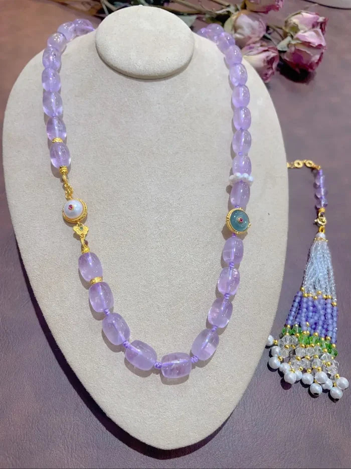 Lavender amethyst tassel necklace on bust display white background showing barrel beads, Crystalvana