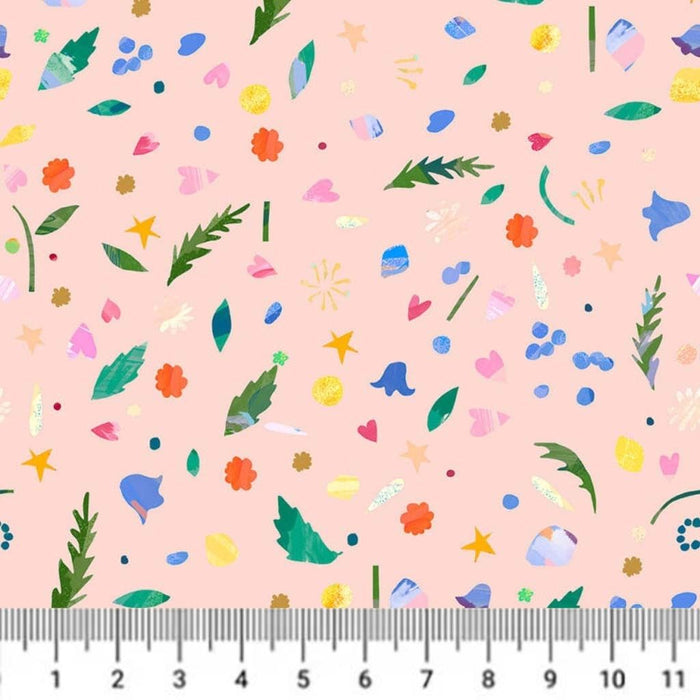 Colourful floral pattern on a pink cotton quilting fabric with a ruler at the bottom.