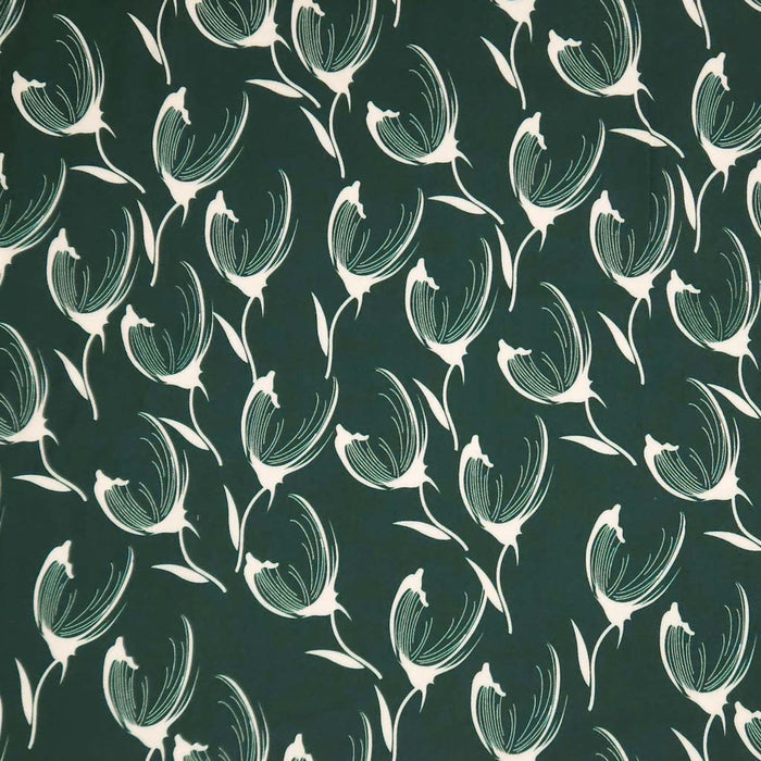 Pattern of white tulips on a dark green viscose twill fabric