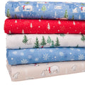 A cotton fat quarter bundle featuring a winter polar bear and Christmas tree pattern in different colors: blue, red, white, light blue, and beige.