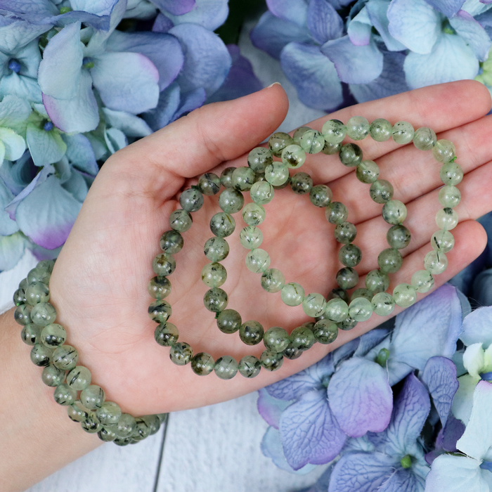 Close-up of natural Prehnite beads showing colour and pattern