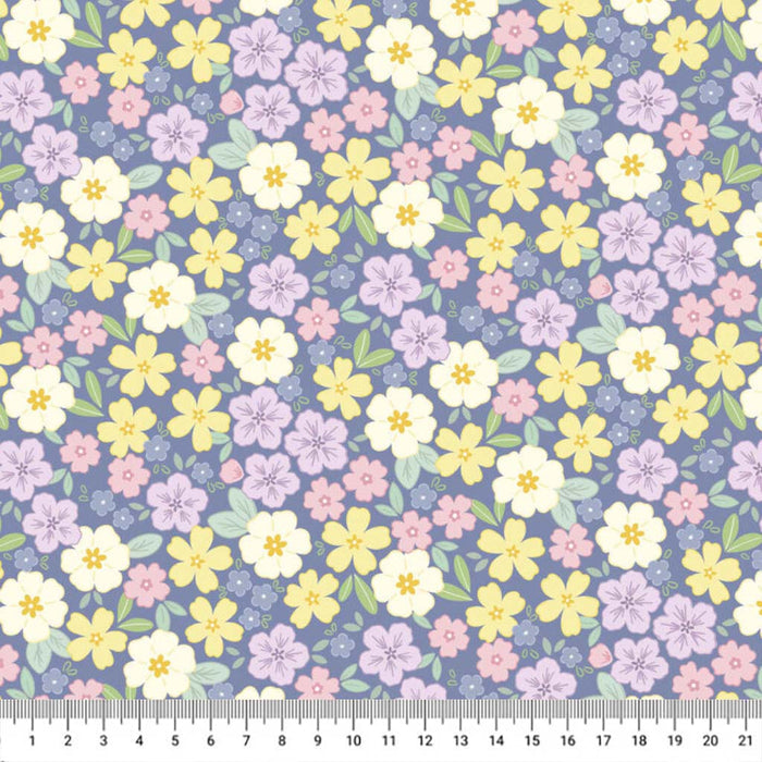 Pastel floral pattern on a blue cotton quilting fabric with a ruler at the bottom.