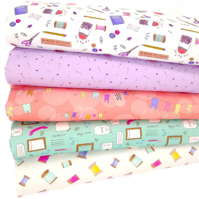 A sewing themed fat quarter fabric bundle in lilacs and mint