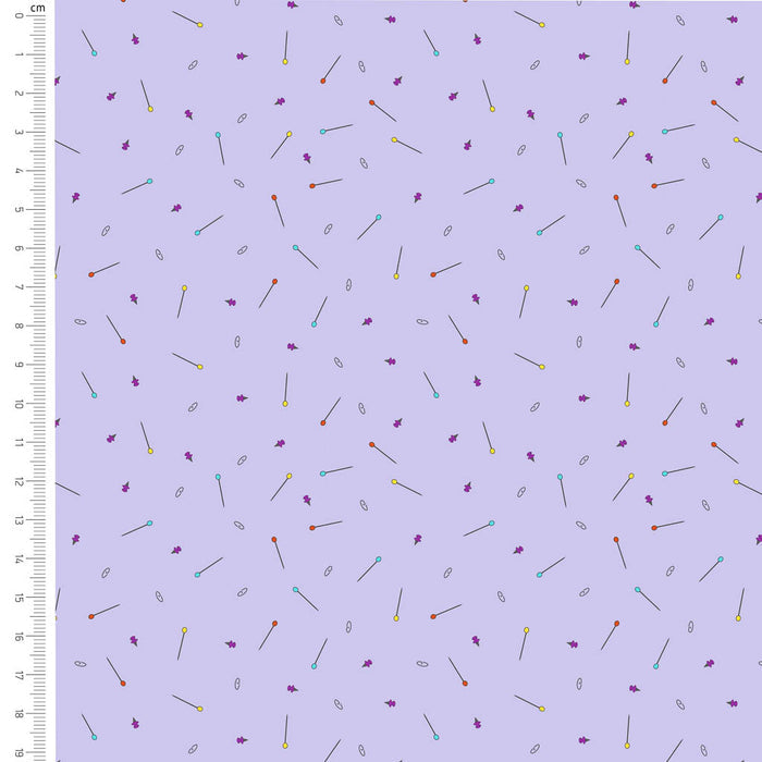 Pins printed on a lilac cotton fabric