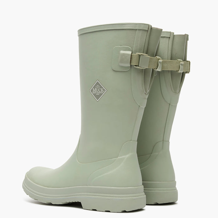 Pair of light green rubber boots with a strap on a white background