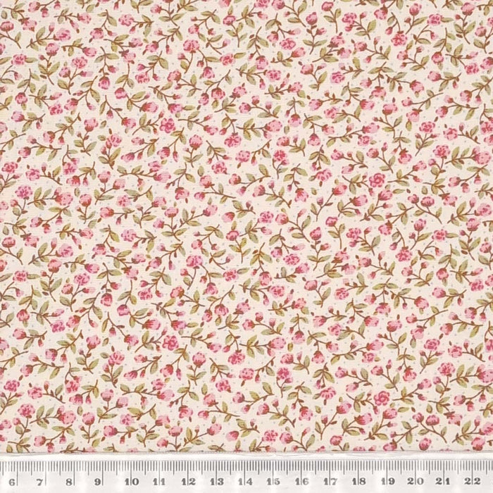 A tiny pink flower design printed on a cotton poplin fabric by Rose & Hubble