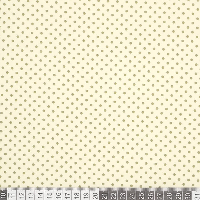 Green mini spots printed on a cream cotton poplin fabric