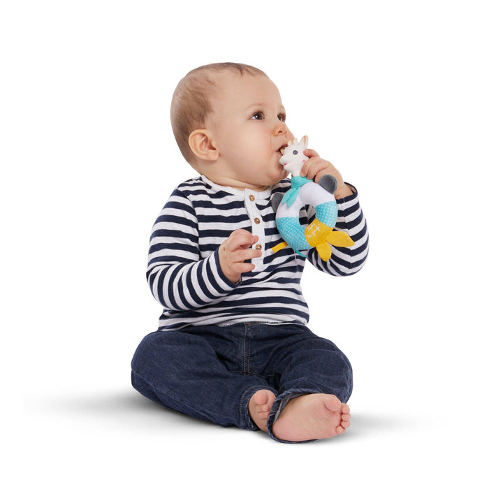 Baby holding and biting on Sophie la Girafe Shake Chew Rattle baby teething toy