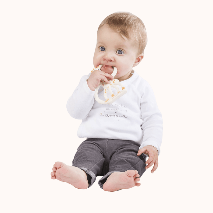 Baby holding Sophie la Girafe natural rubber Teething Ring