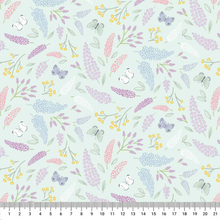Butterflies printed on a mint cotton quilting fabric with a cm ruler