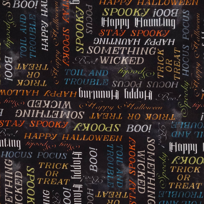 A close-up of a Halloween-themed fabric pattern featuring various spooky words like 'BOO!', 'SPOOKY', 'HAPPY HALLOWEEN', 'STAY SPOOKY', and 'TOIL AND TROUBLE' in white, orange, and light blue on a dark charcoal background.