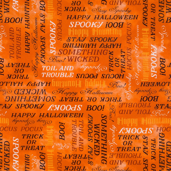 A close-up of an orange Halloween-themed cotton fabric featuring repeated black and yellow text such as 'Spooky', 'Happy Halloween', 'Boo!', 'Stay Spooky', and 'Trick or Treat'.