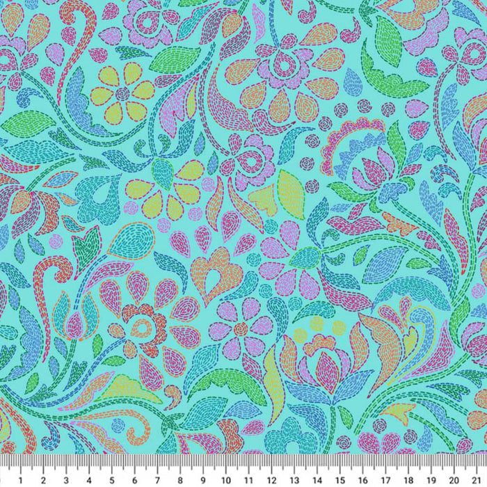 Colorful floral and paisley pattern on a teal cotton quilting fabric with a ruler at the bottom.