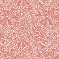 Patterned fabric with red floral and bird design on a light pink cotton quilting fabric