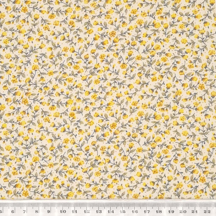 Tiny yellow flowers printed on a cotton poplin fabric