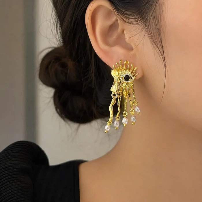 Model wearing Venetian mask pearl drop gold-tone artistic dangle earrings, Crystalvana