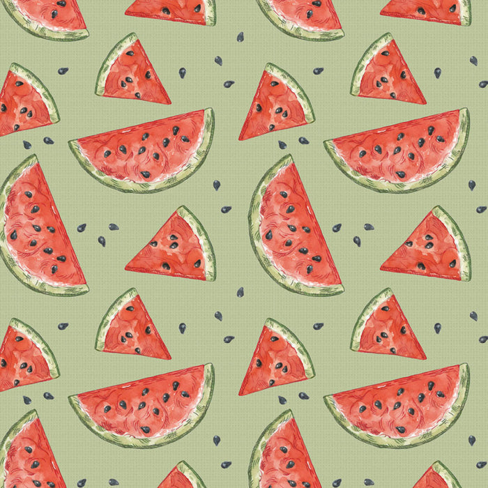 Pattern of watermelon slices on a green cotton quilting fabric