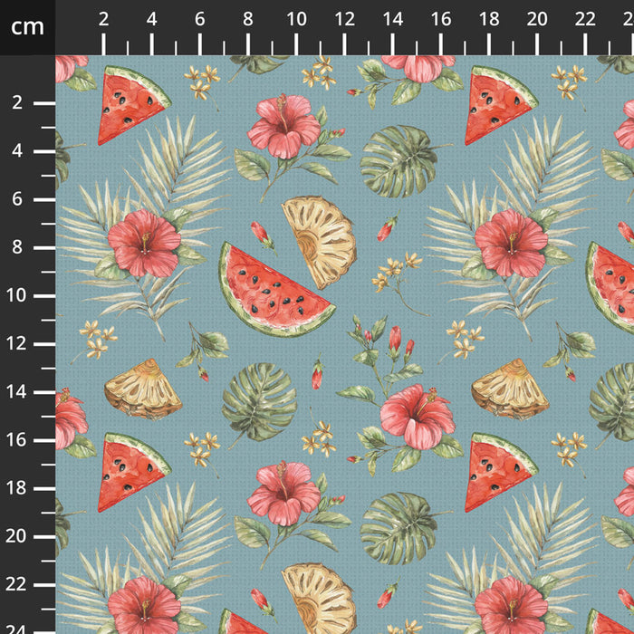 Cotton quilting fabric with tropical pattern including watermelon slices, pineapples, and flowers on a blue background.