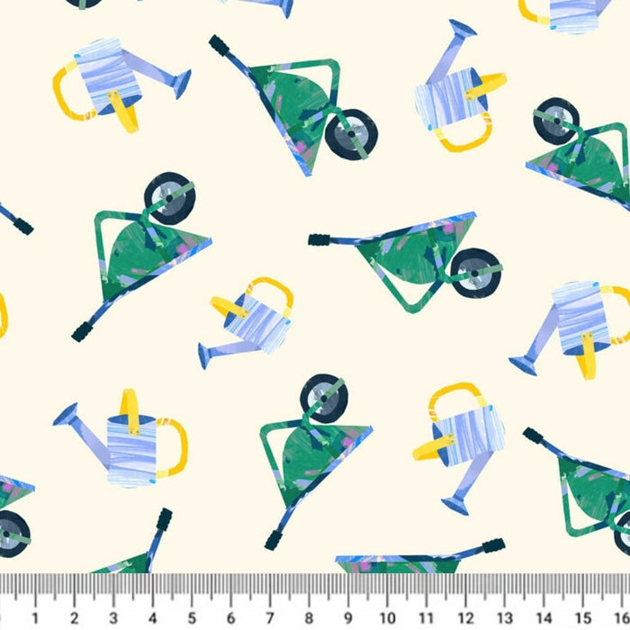 Pattern of colorful watering cans and wheelbarrows on a white cotton quilting fabric with a ruler at the bottom.