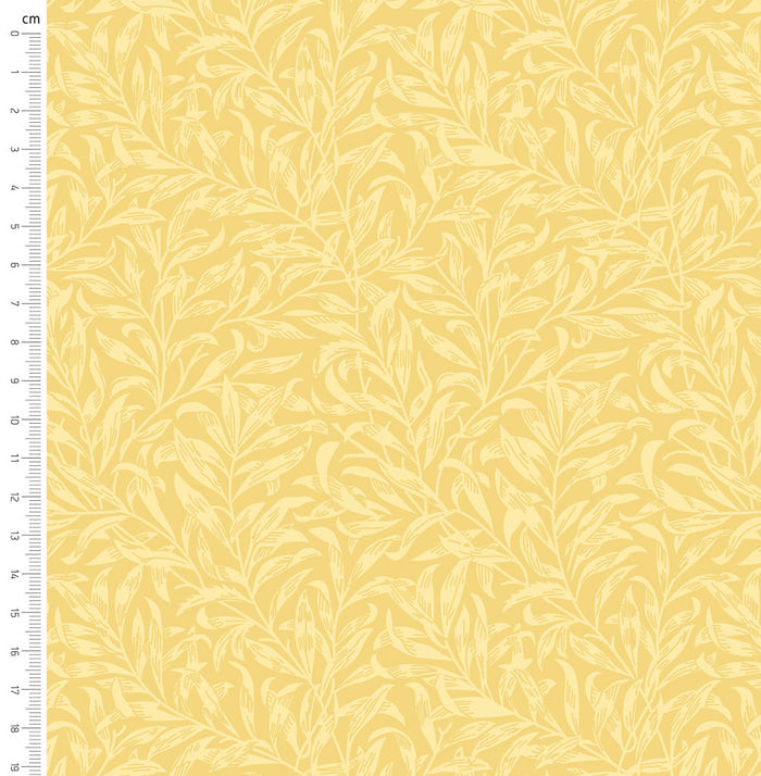 Pastel yellow willow bough design printed on quilting fabric with a cm ruler