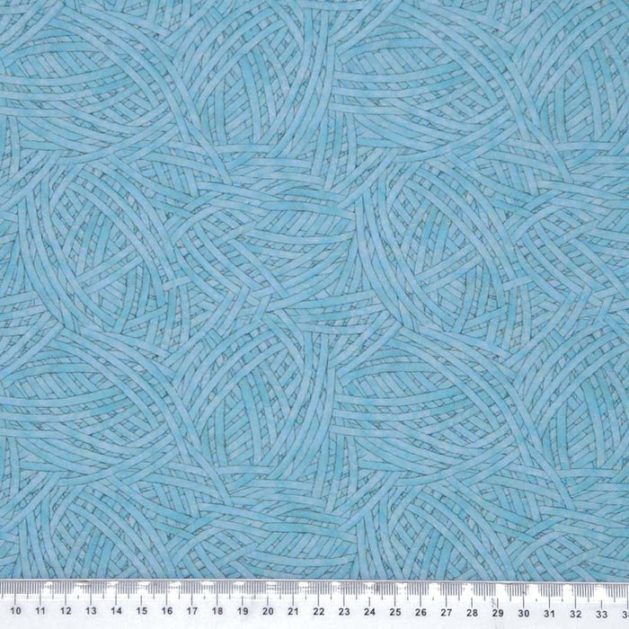 Blue textured pattern fabric swatch with a ruler at the bottom